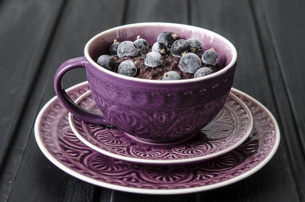 Decadent Instant Pot chocolate oatmeal - made even better with berries and a drizzle of cream. Yum!